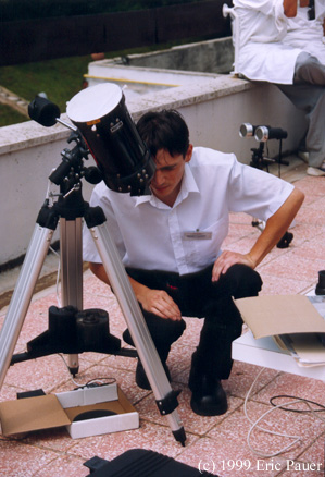 Hungarian waiter enjoys the view of partially eclipsed sun
